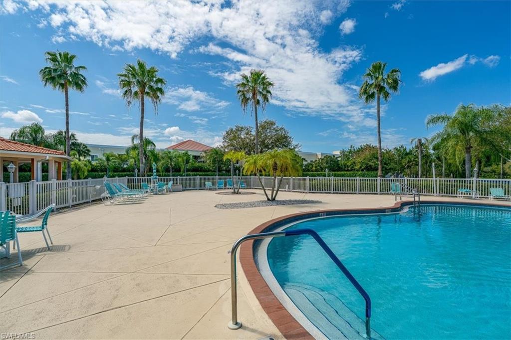 186 Gabriel Circle, Unit 3903 Naples, FL 34104 - Photo 26 of 42 Community pool with a patio