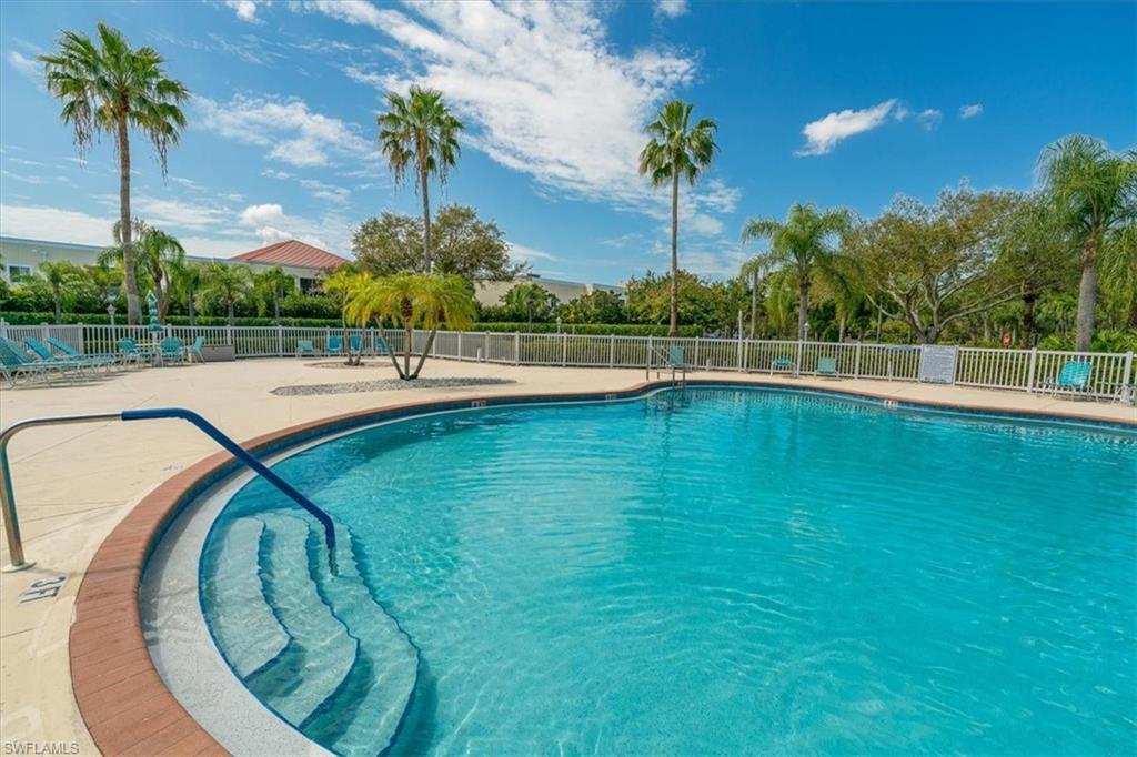 186 Gabriel Circle, Unit 3903 Naples, FL 34104 - Photo 27 of 42 Community pool featuring a patio