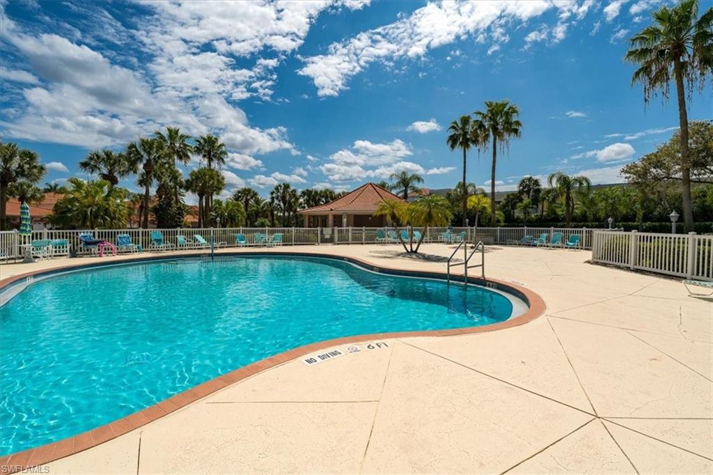 186 Gabriel Circle, Unit 3903 Naples, FL 34104 - Photo 29 of 42 Community pool with a patio area
