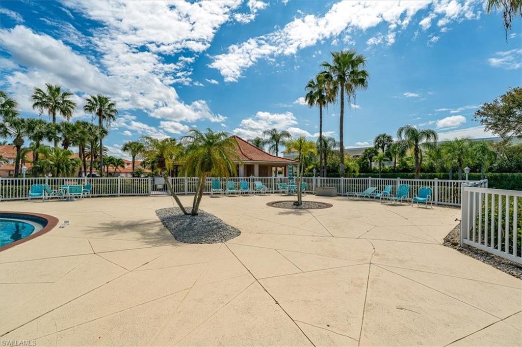186 Gabriel Circle, Unit 3903 Naples, FL 34104 - Photo 31 of 42 Community pool with a patio