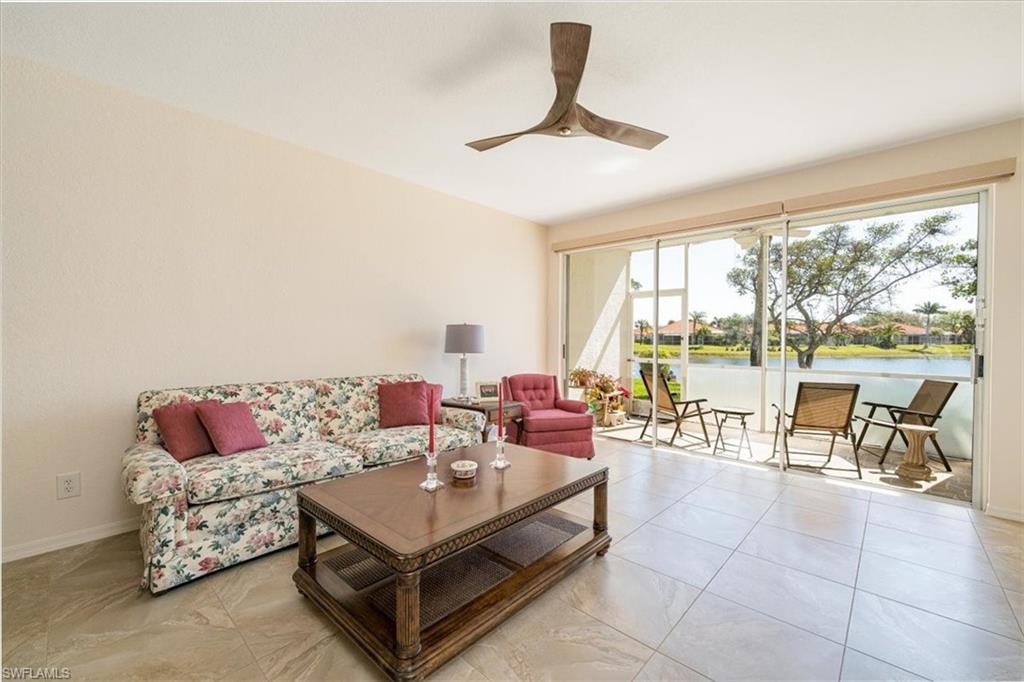 186 Gabriel Circle, Unit 3903 Naples, FL 34104 - Photo 5 of 42 Living area featuring a water view and ceiling fan