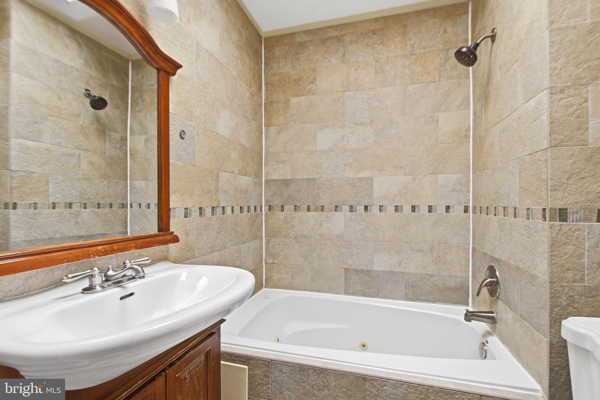 440 Delafield Place Northwest Washington, DC 20011 - Photo 23 of 33 a bath tub sitting next to a bathroom sink