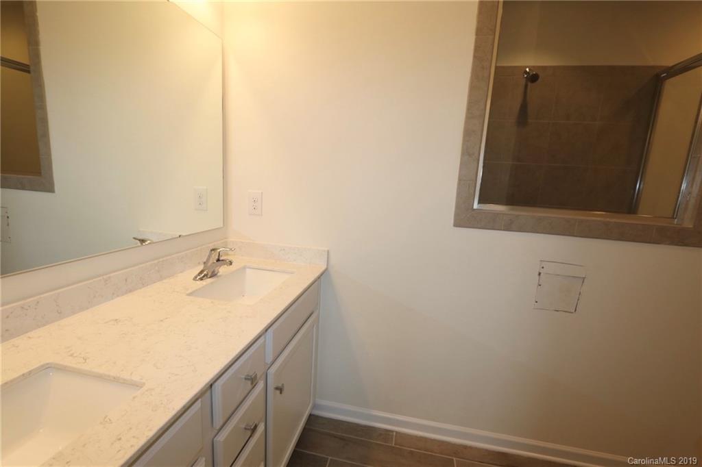 623 Amber Meadows Way, Unit 273 Tega Cay, SC 29708 - Photo 6 of 9 a bathroom with a sink and a mirror