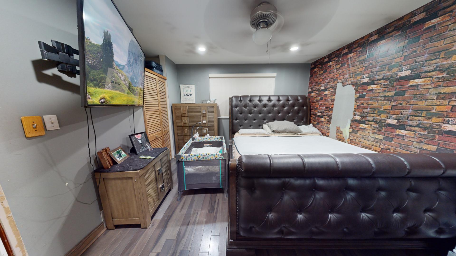 327 South 18th Street Chesterton, IN 46304 - Photo 11 of 29 a bedroom with a bed and wooden floor