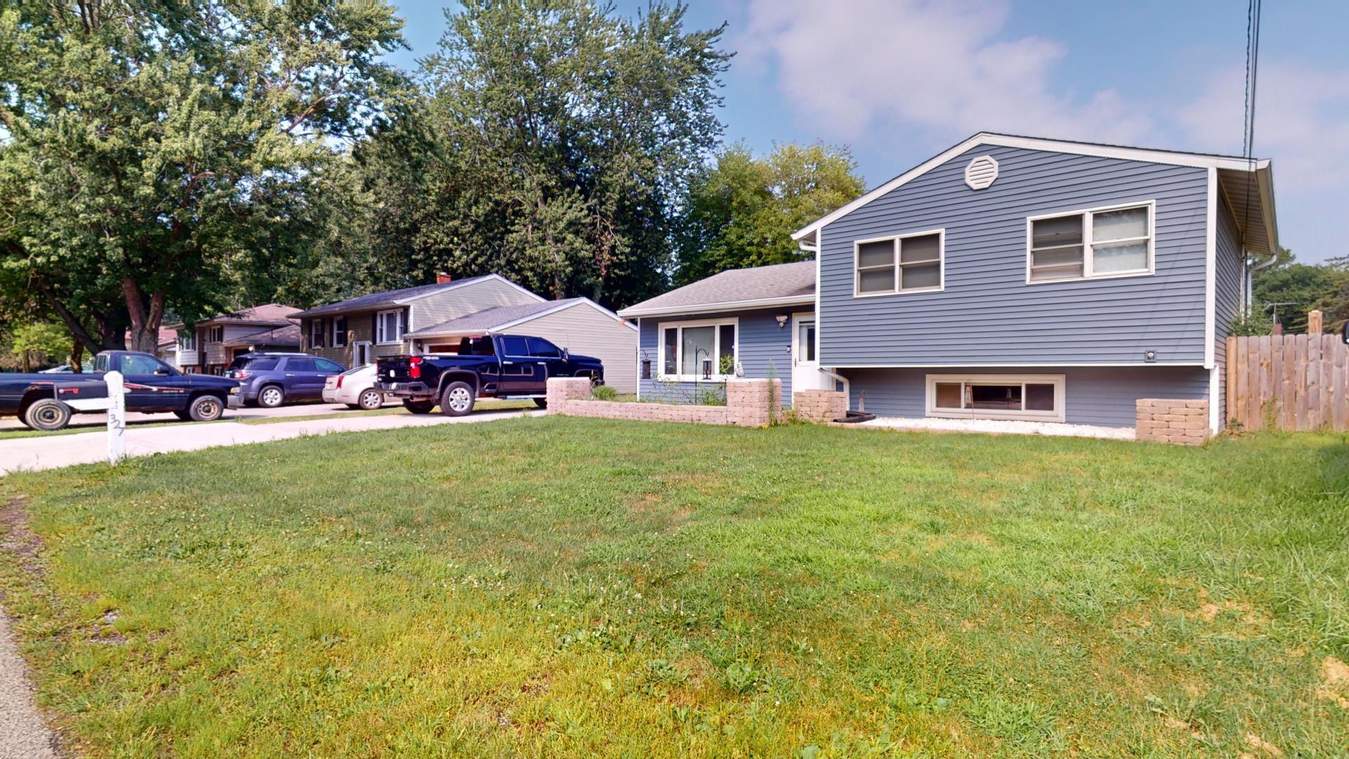 327 South 18th Street Chesterton, IN 46304 - Photo 2 of 29 a front view of a house with a garden and porch