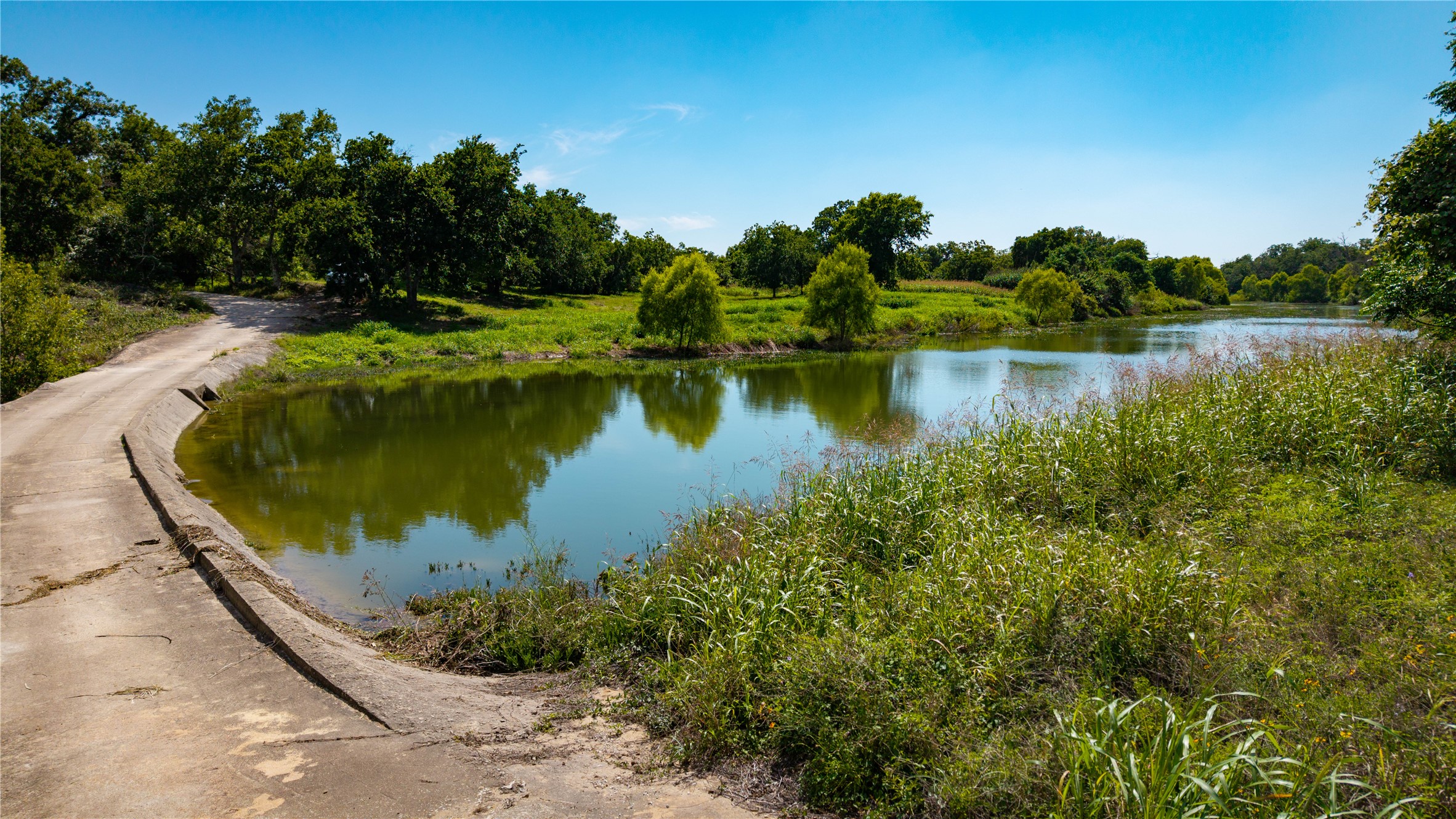 Tbd Lost Acres Loop Blanco, TX 78606 - Photo 13 of 39 a view of a lake with a yard and large trees