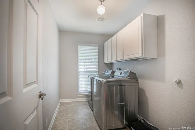a view of a storage and utility room with washer and dryer