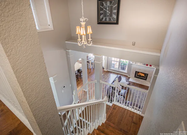 a view of a livingroom with wooden floor and stairs