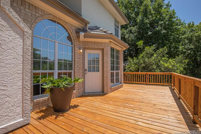 a view of balcony with wooden floor