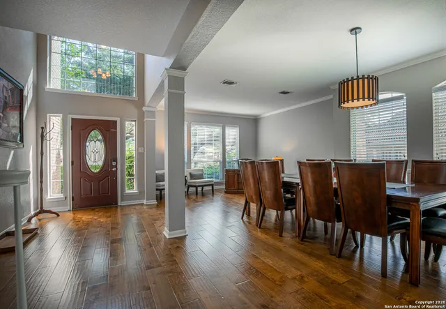 a view of a livingroom with furniture window and wooden floor