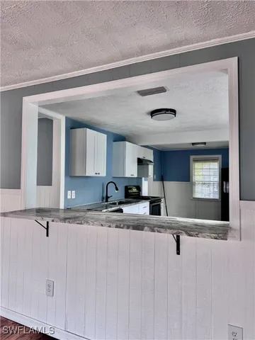 a view of kitchen with sink and window