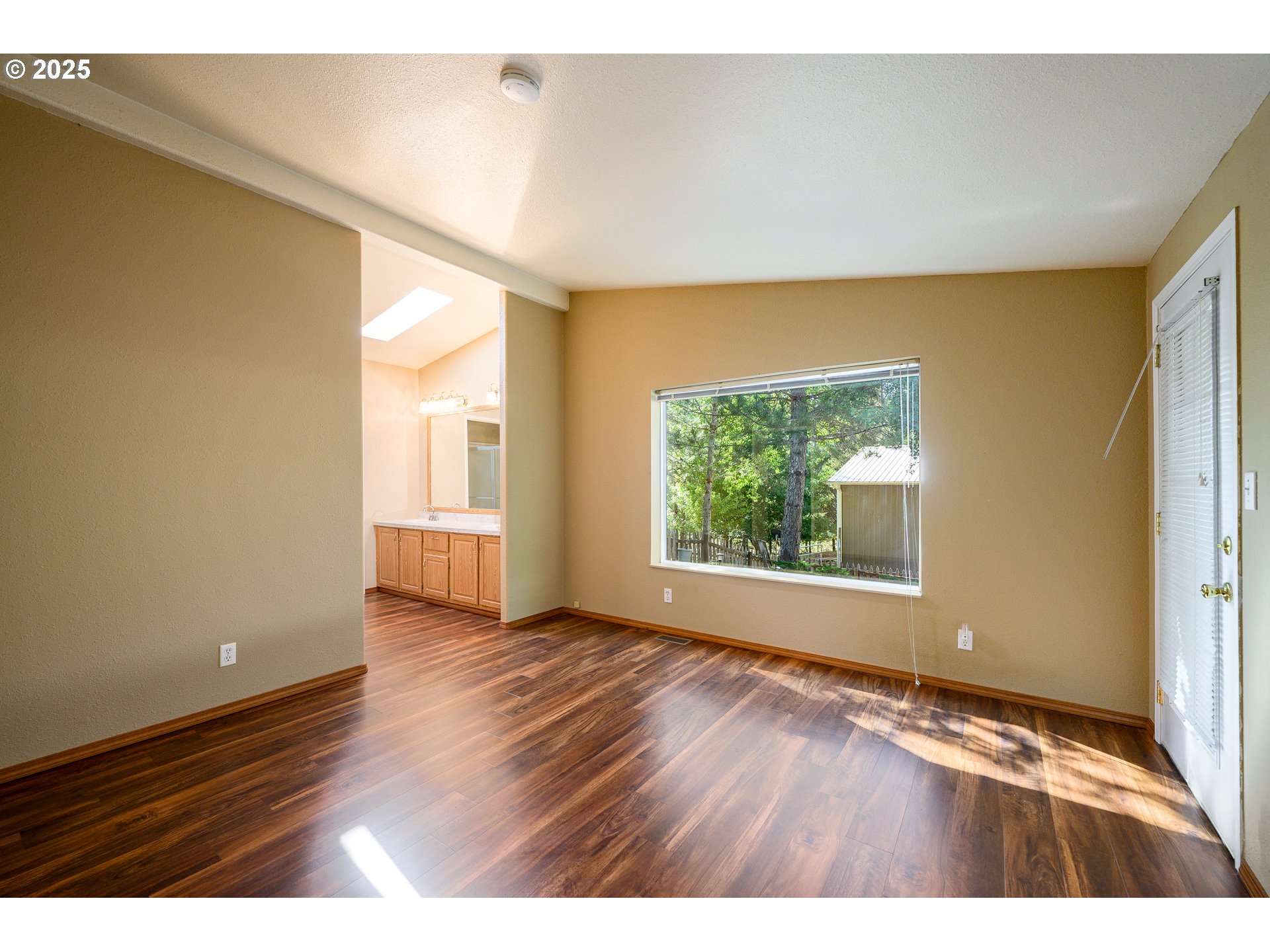 13330 Willamina Creek Road Willamina, OR 97396 - Photo 18 of 46 a view of an empty room with wooden floor and a window