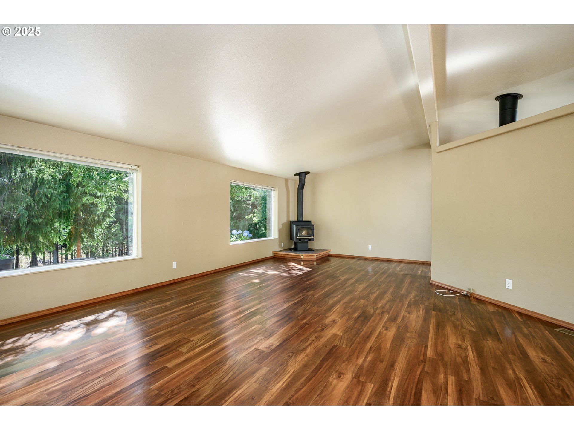 13330 Willamina Creek Road Willamina, OR 97396 - Photo 9 of 46 a view of an empty room with wooden floor and a window