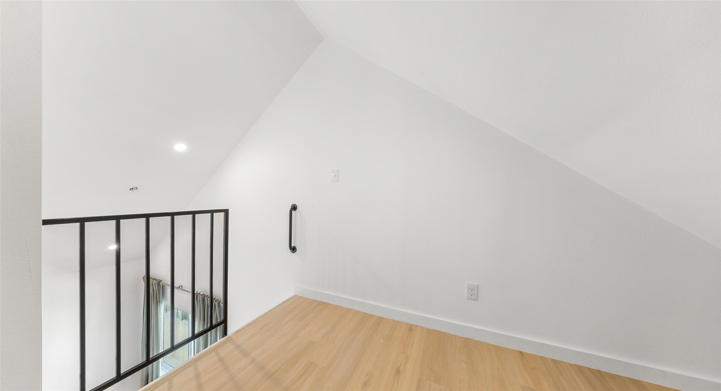 5912 Harold Court, Unit 107 Austin, TX 78721 - Photo 30 of 35 A loft landing with warm wood floors — bonus space for a reading corner, a studio, or a quiet escape. Model No. 105 Shown.
