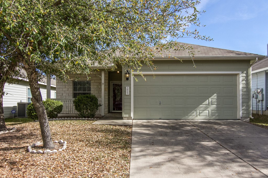3913 Bronco Bend Loop Austin, TX 78744 - Photo 1 of 1 a front view of a house with garden