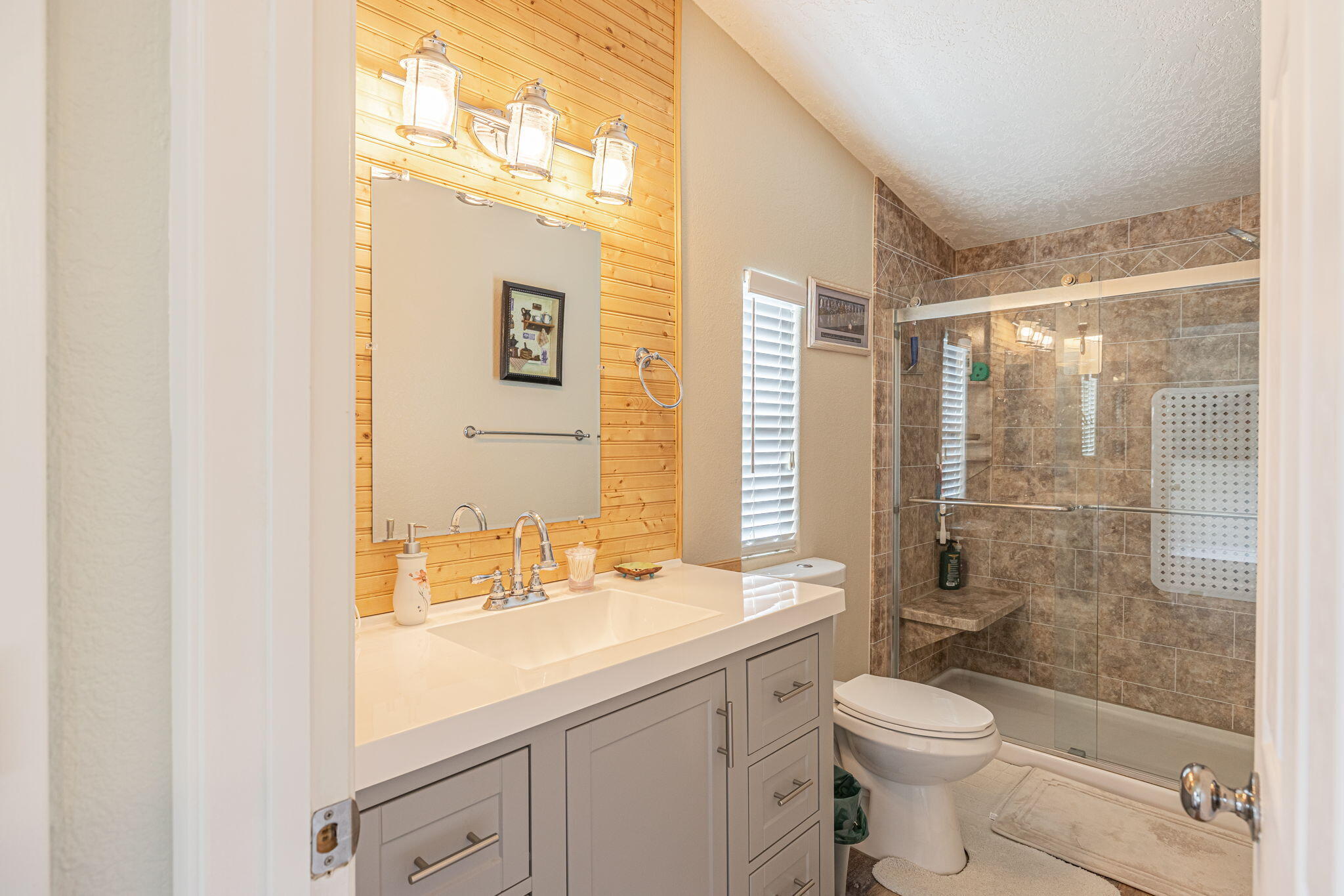 33105 Santiago Road Acton, CA 93510 - Photo 14 of 73 a bathroom with a granite countertop sink toilet and shower