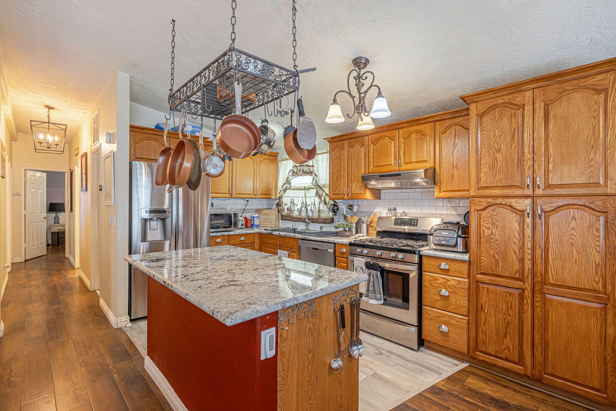 33105 Santiago Road Acton, CA 93510 - Photo 21 of 73 a kitchen with stainless steel appliances granite countertop a sink a stove and a wooden floors
