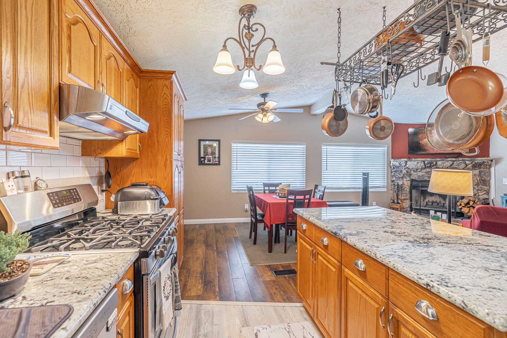 33105 Santiago Road Acton, CA 93510 - Photo 22 of 73 a kitchen with stainless steel appliances granite countertop a stove a sink dishwasher and cabinets with wooden floor