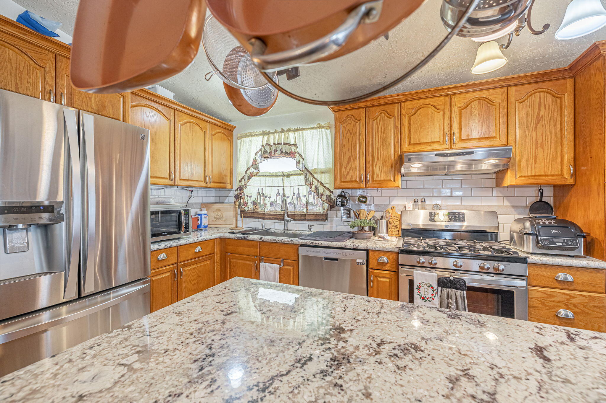 33105 Santiago Road Acton, CA 93510 - Photo 23 of 73 a kitchen with stainless steel appliances granite countertop a stove and refrigerator