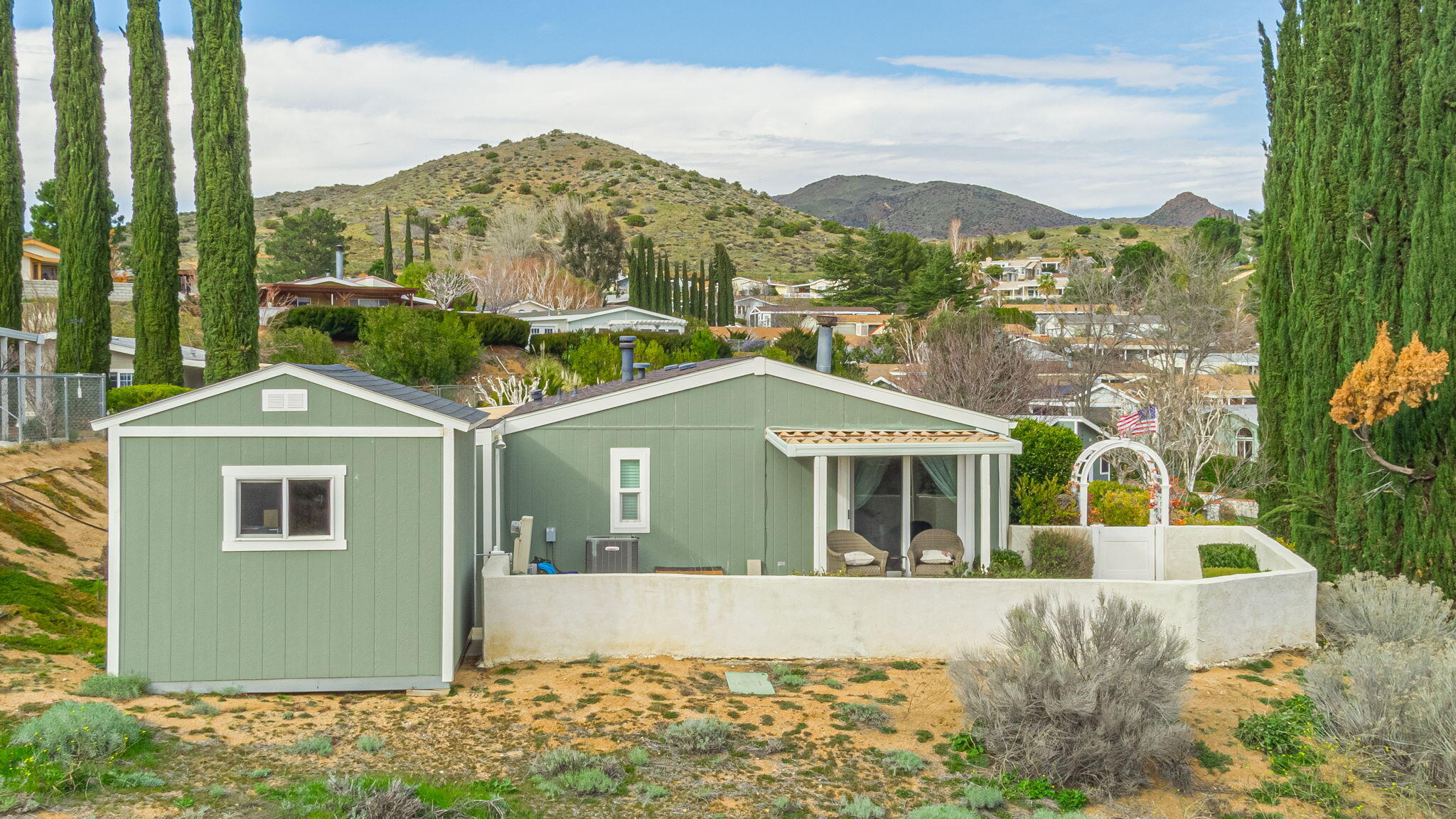 33105 Santiago Road Acton, CA 93510 - Photo 54 of 73 a front view of a house with a yard and potted plants