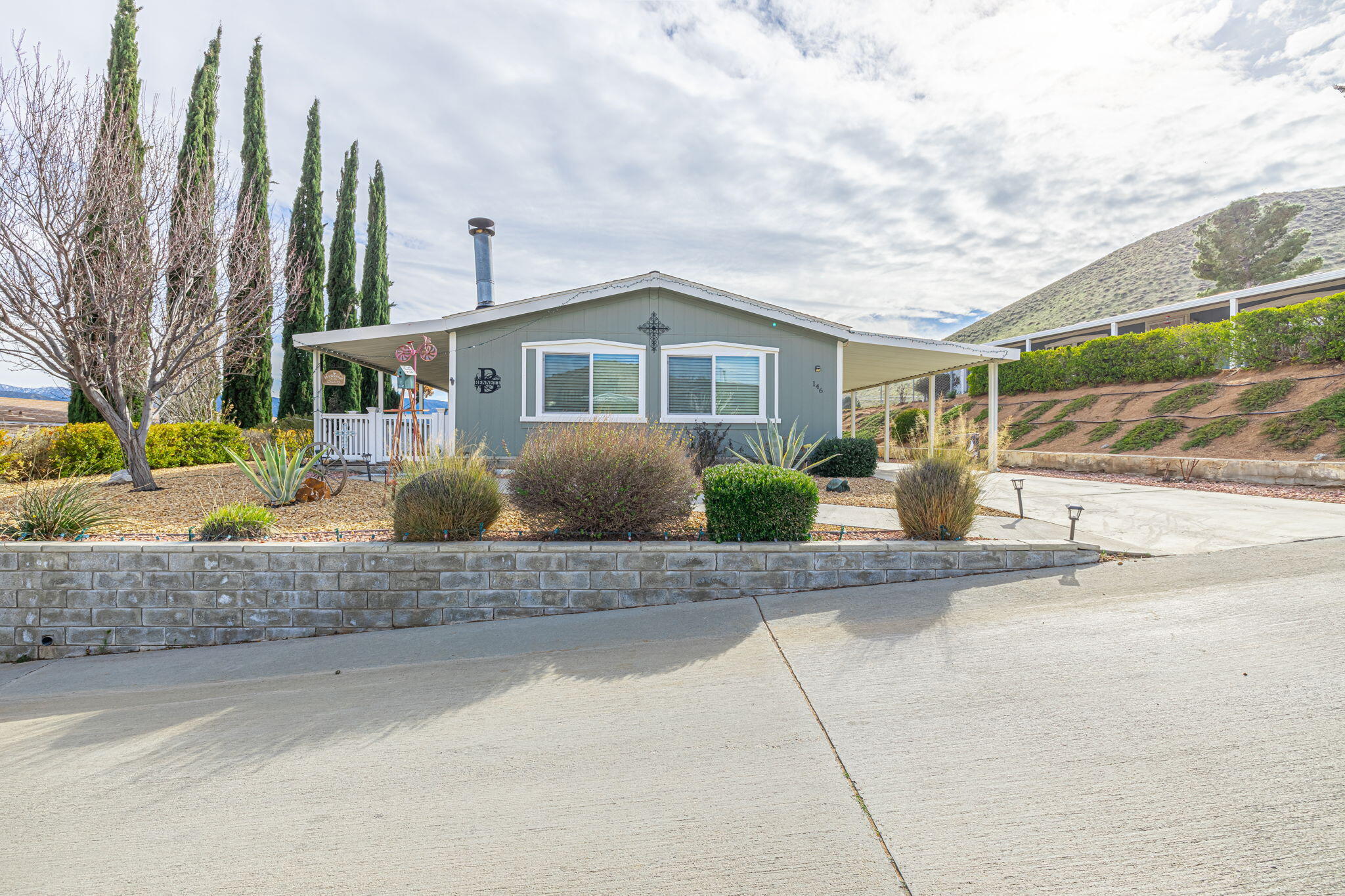 33105 Santiago Road Acton, CA 93510 - Photo 6 of 73 a front view of a house with a yard and potted plants