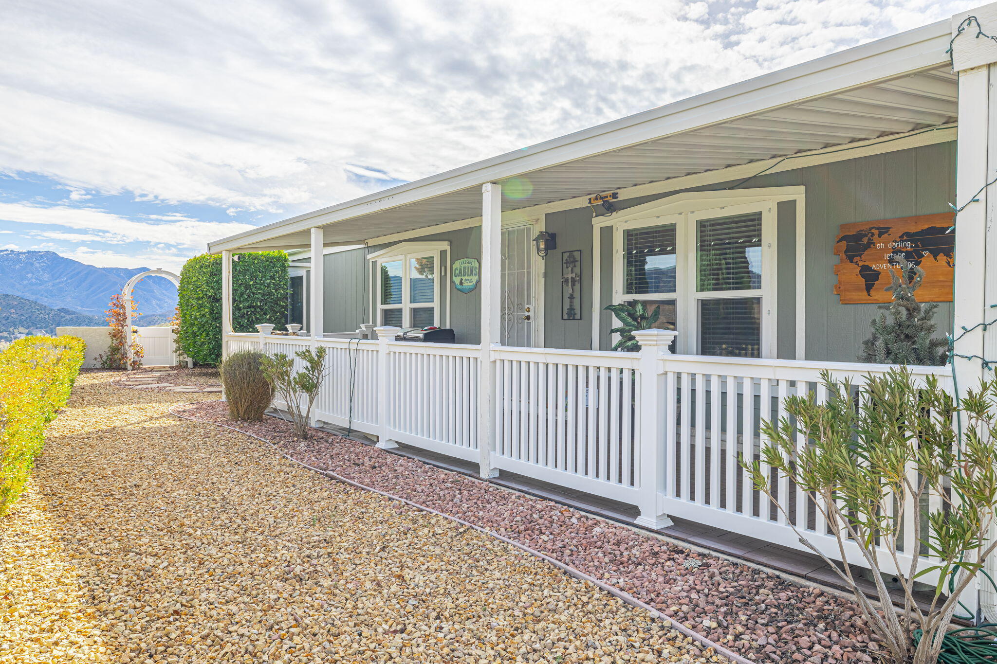 33105 Santiago Road Acton, CA 93510 - Photo 8 of 73 a porch with a table and chairs and potted plants