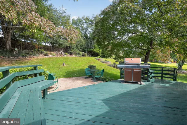 a backyard of a house with barbeque oven and outdoor seating
