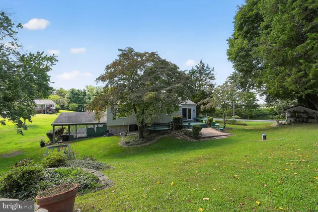 a front view of a house with a yard and outdoor seating