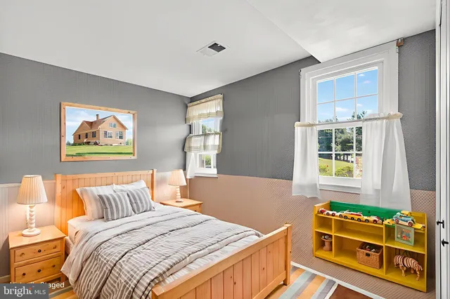 a bedroom with furniture and a window