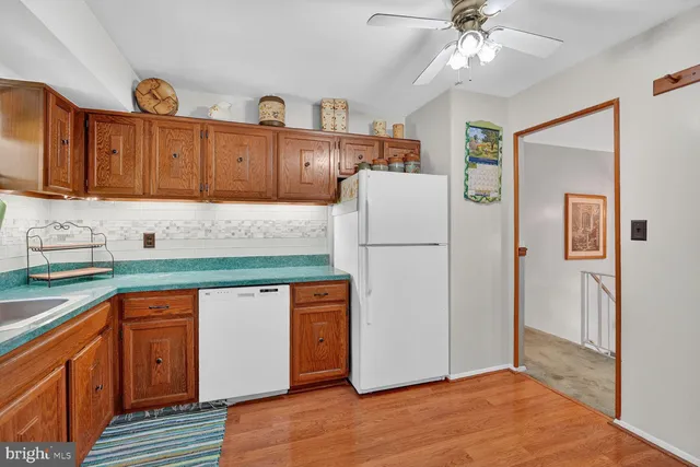 a kitchen with stainless steel appliances granite countertop a refrigerator a sink and dishwasher