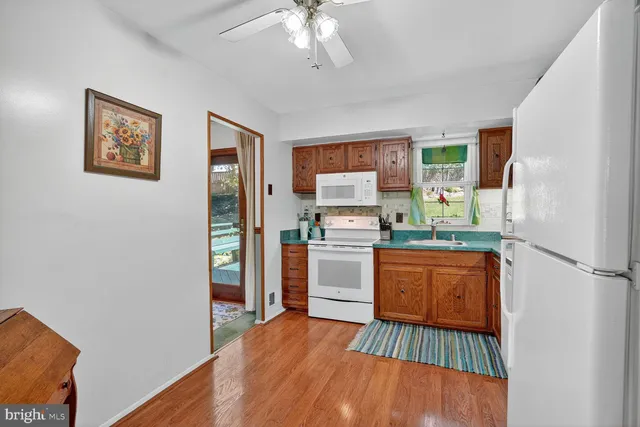 a kitchen with stainless steel appliances granite countertop a refrigerator sink and stove