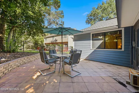 an aerial view of residential houses with outdoor space and trees