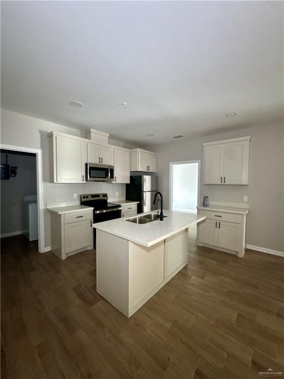 720 Ragland Road, Unit 8 Mission, TX 78572 - Photo 14 of 17 a kitchen that has a lot of white cabinets and wooden floor