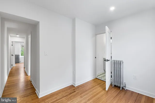 a view of a hallway with wooden floor