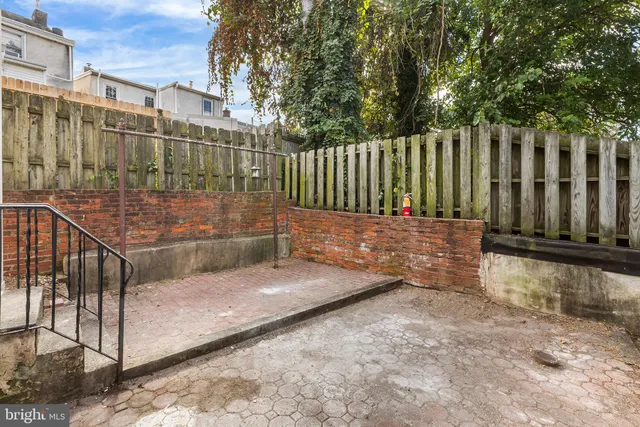 a view of a pathway with a wrought fence