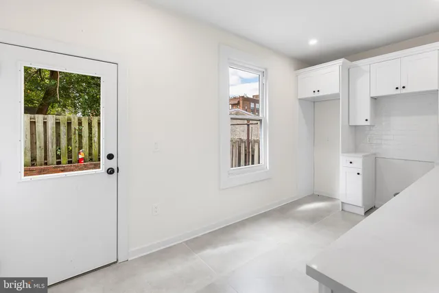a view of kitchen with furniture and windows