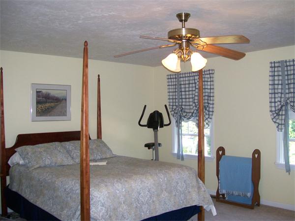 2 Forge Lane Sutton, MA 01590 - Photo 11 of 18 a bedroom with a bed and a chandelier