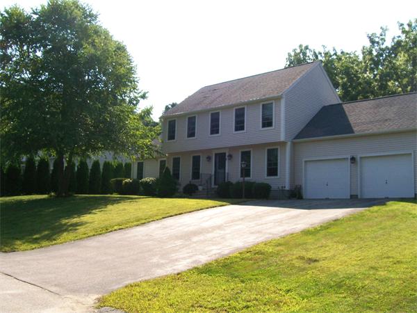 2 Forge Lane Sutton, MA 01590 - Photo 2 of 18 a front view of a house with a yard and trees