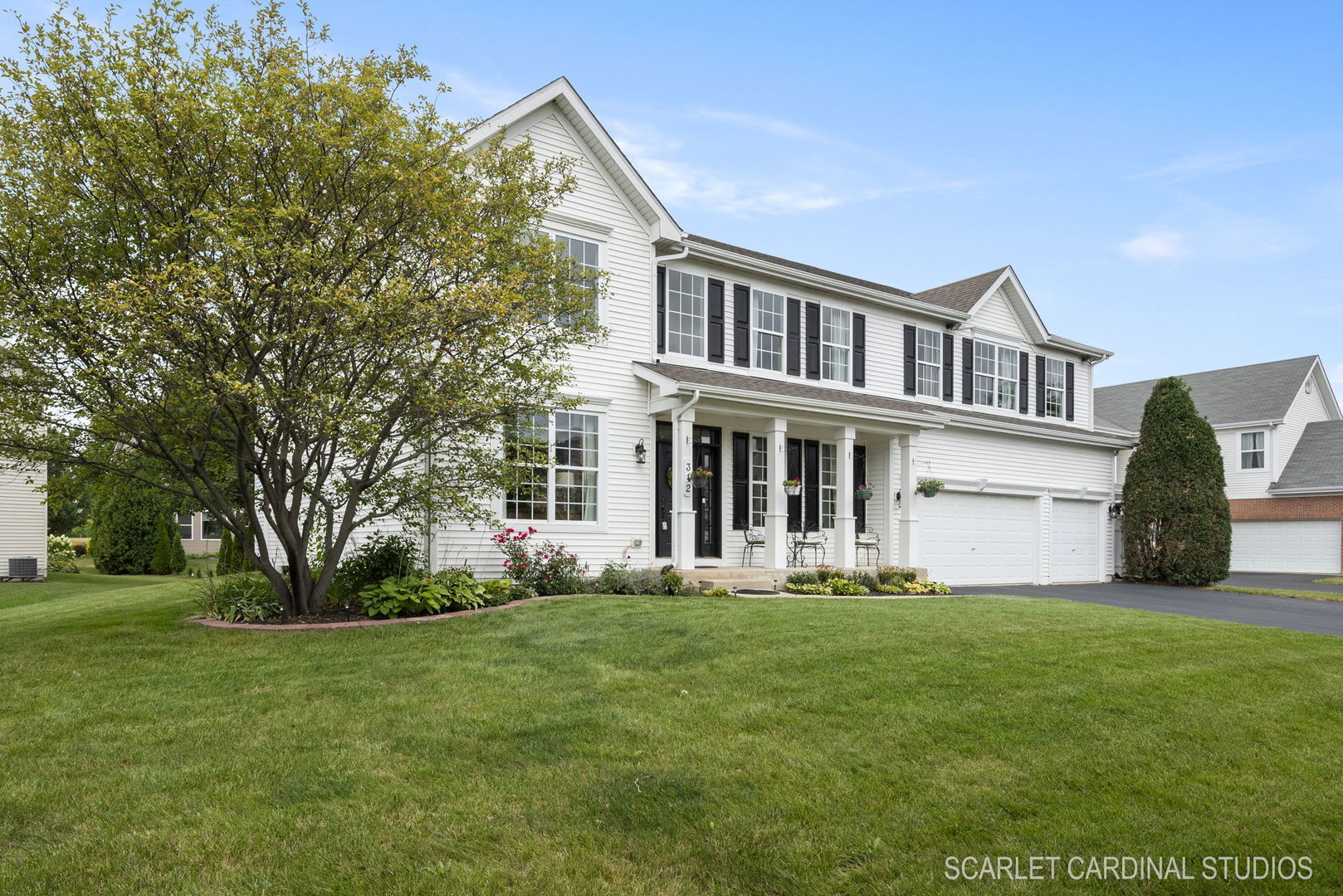 312 Veronica Circle Bartlett, IL 60103 - Photo 2 of 45 a front view of a house with a yard and trees