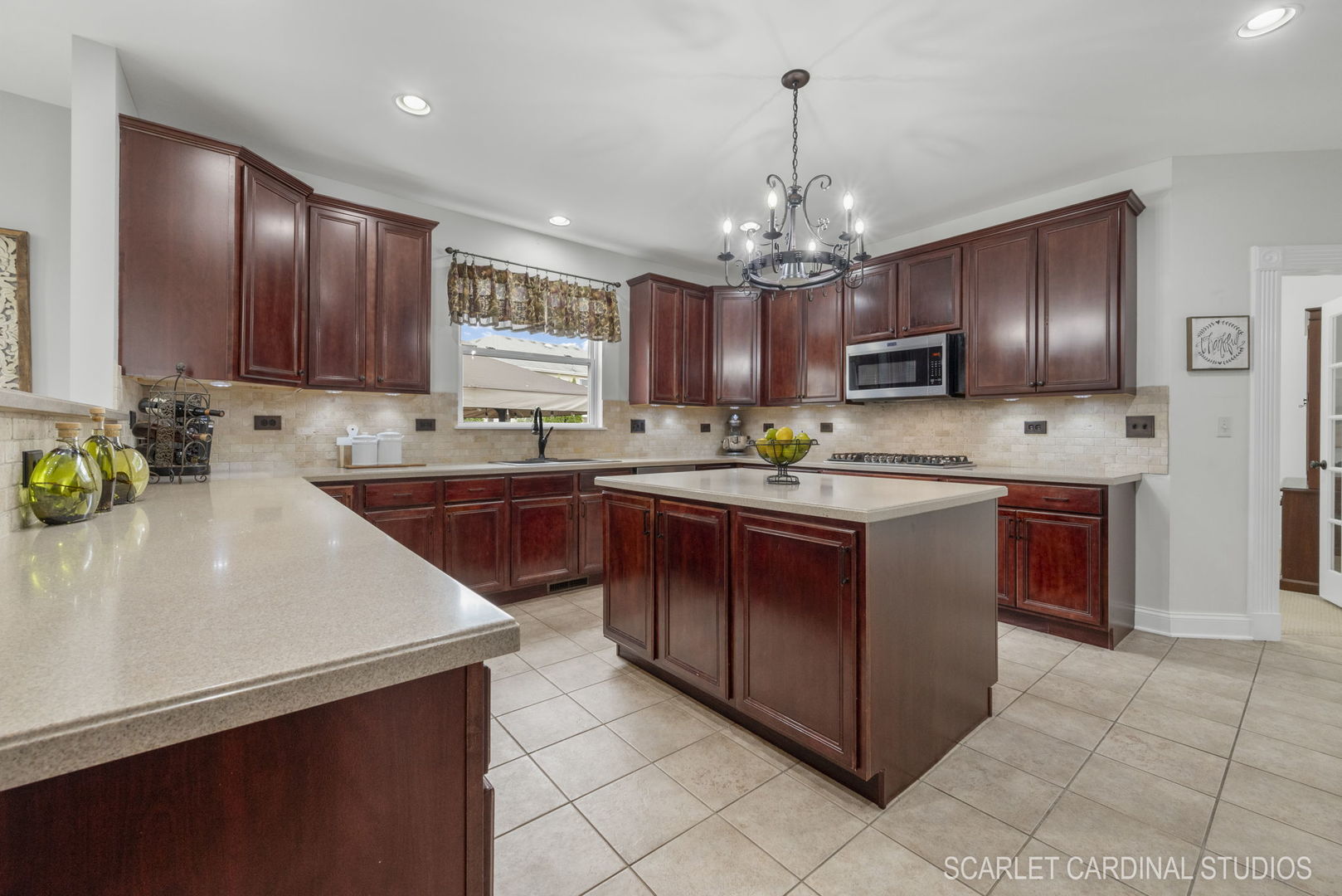 312 Veronica Circle Bartlett, IL 60103 - Photo 10 of 45 a kitchen with kitchen island granite countertop a sink counter top space appliances and cabinets