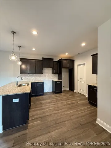 an empty room with a window and a ceiling fan