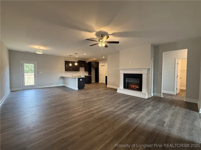 a view of an empty room with a fireplace and a window