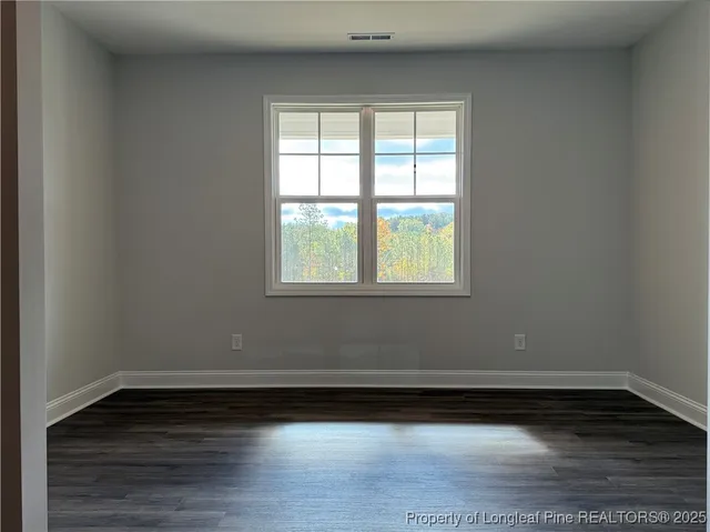 a kitchen with stainless steel appliances granite countertop a sink a stove and a wooden floor