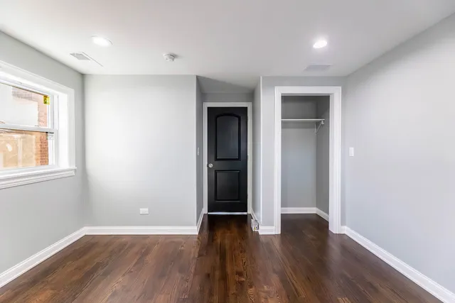 a picture of a bench in front of a wall