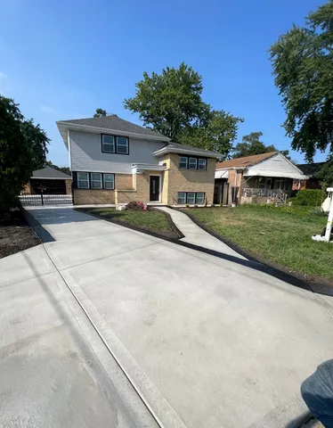 a living room with furniture kitchen view and a large window