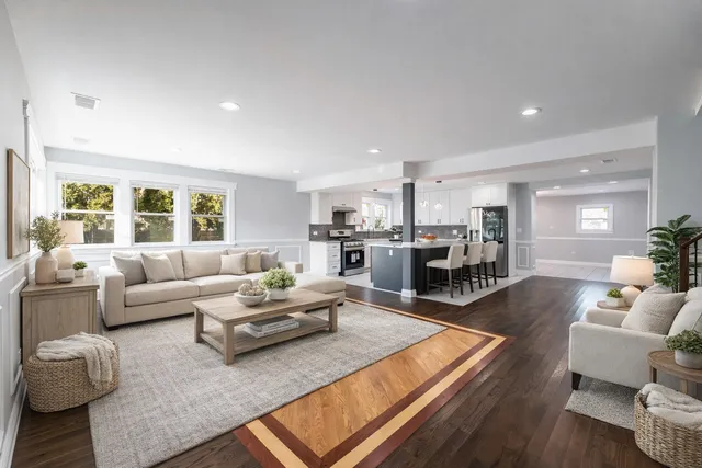 a view of empty room with wooden floor and fireplace