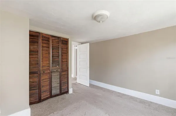 an empty room with walk in closet and bathroom