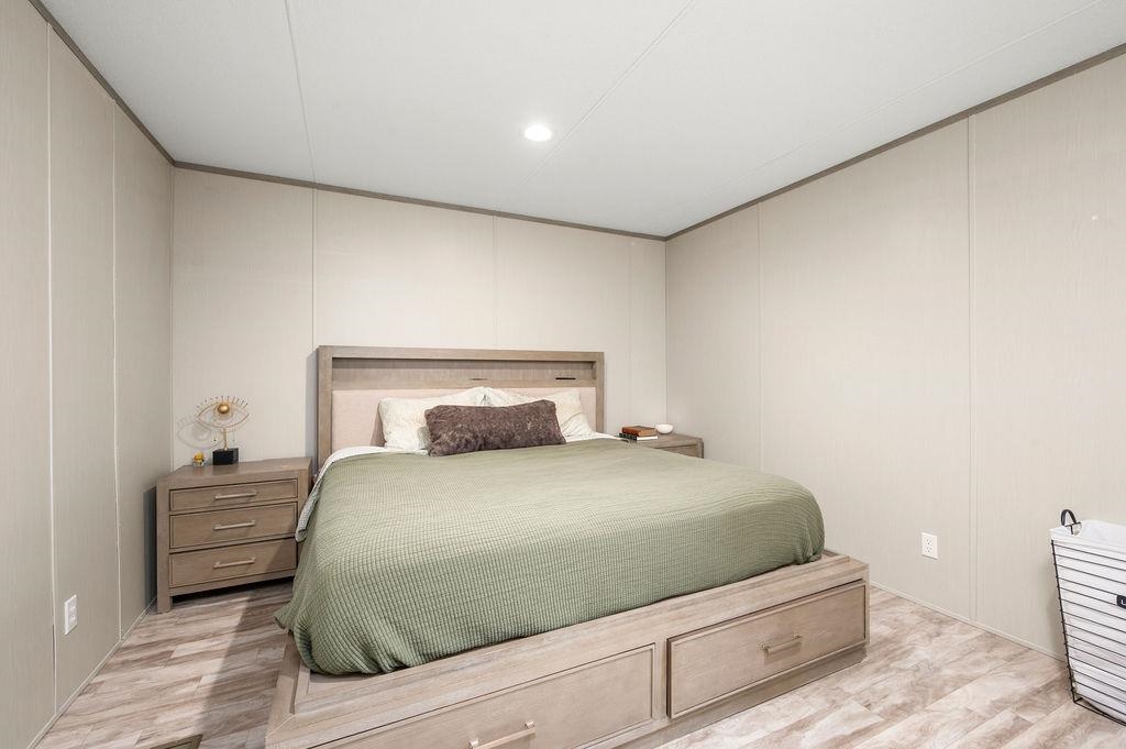 271 Clements Way Fruita, CO 81521 - Photo 11 of 26 a bedroom with a bed and mirror