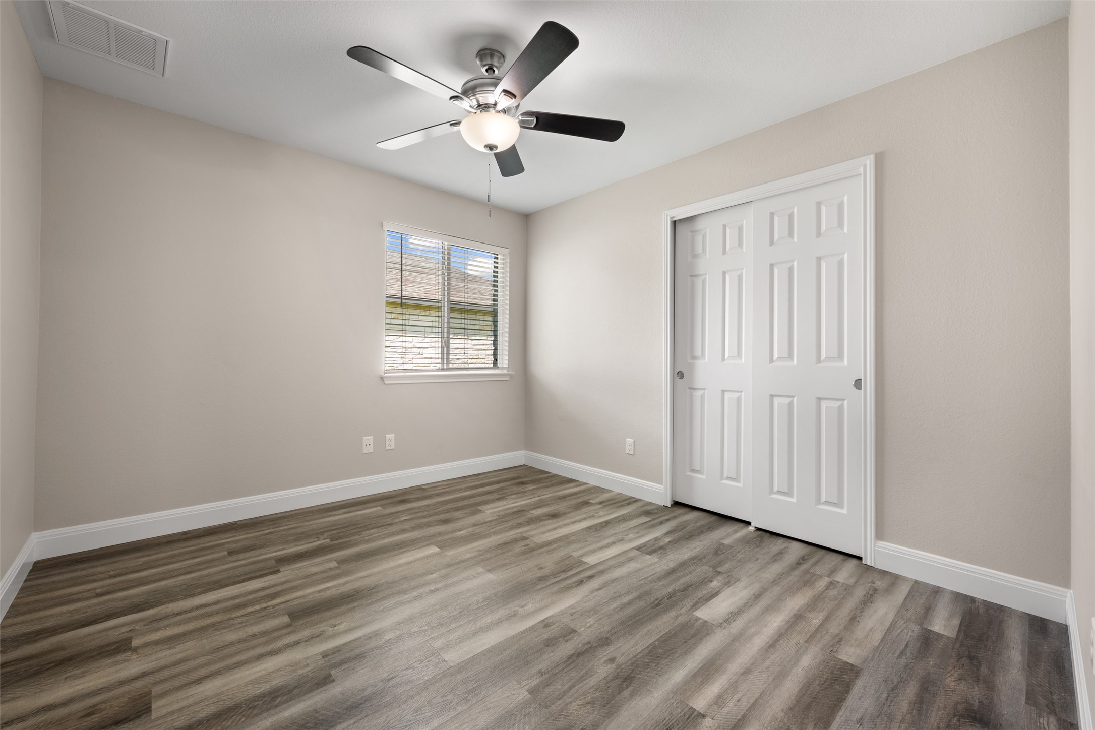 18820 Edinburgh Castle Road Pflugerville, TX 78660 - Photo 31 of 37 an empty room with wooden floor and windows
