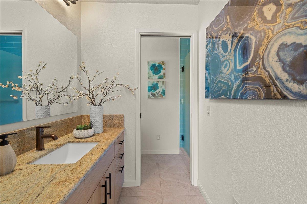 6109 Sheraton Place Aptos, CA 95003 - Photo 14 of 31 a bathroom with a granite countertop sink and a mirror